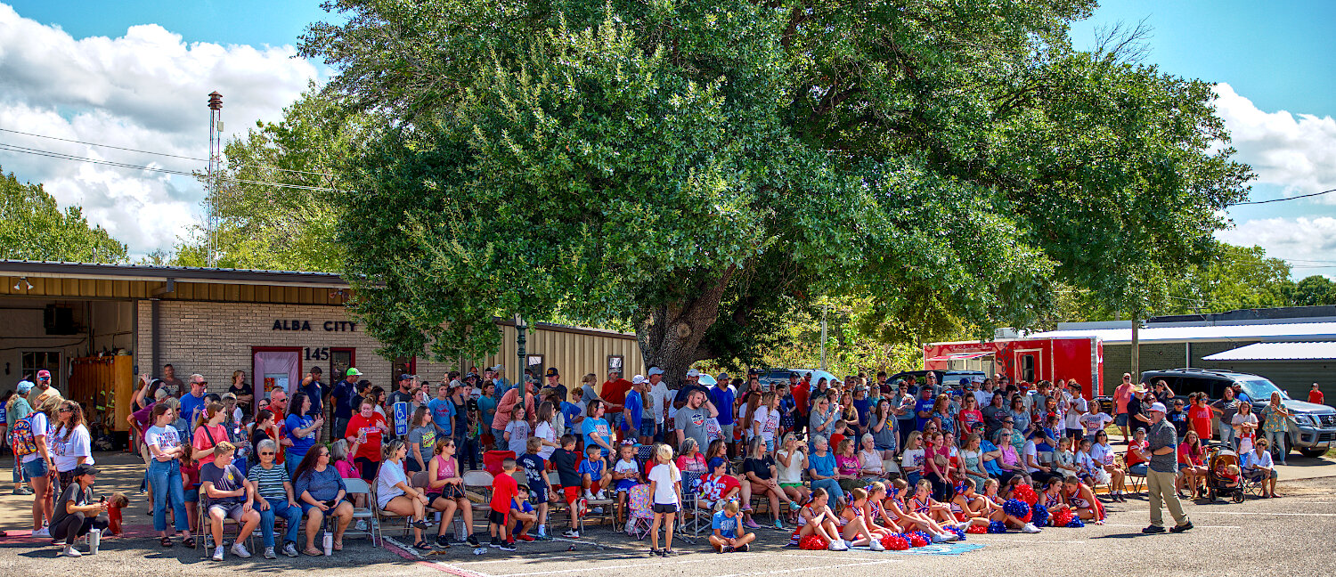 Plentiful shade of the tree at Alba City Hall was sought out by much of the crowd at the inaugural community homecoming pep rally. [preview plenty of panther pictures]